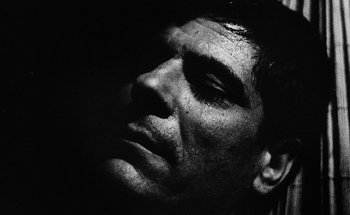 Movie still from “La Jetée” (1962), directed by Chris Marker – A man's face in a black and white photo; Close Up shot, Low angle