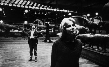 Movie still from “La Jetée” (1962), directed by Chris Marker – A woman standing next to an animal in a room; Wide shot, Over the shoulder angle