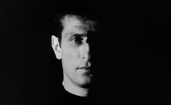 Movie still from “La Jetée” (1962), directed by Chris Marker – A black and white photo of a man's face; Close Up shot, Low angle