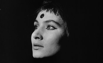 Movie still from “La Jetée” (1962), directed by Chris Marker – A black and white photo of a woman with a face tattoo; Close Up shot, Low angle