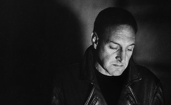 Movie still from “La Jetée” (1962), directed by Chris Marker – Black and white photograph of a man wearing a leather jacket; Close Up shot, Low angle