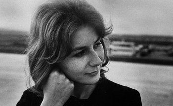 Movie still from “La Jetée” (1962), directed by Chris Marker – A black - and - white photo of a woman with her hand on her head; Close Up shot, Low angle