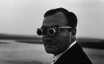 Movie still from “La Jetée” (1962), directed by Chris Marker – A black and white photo of a man wearing a pair of binoculars; Close Up shot, Low angle
