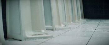 Movie still from “La Llorona” (2019), directed by Jayro Bustamante – A row of white chairs on a tiled floor; Extreme Close Up shot, High angle