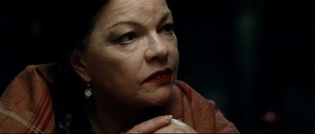 Movie still from “La Vie En Rose” (2007), directed by Olivier Dahan – An older woman with red lipstick looking at the camera; Close Up shot, Low angle