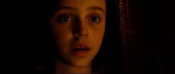 Movie still from “La Vie En Rose” (2007), directed by Olivier Dahan – A person's face in the dark; Close Up shot, High angle