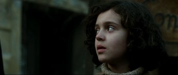 Movie still from “La Vie En Rose” (2007), directed by Olivier Dahan – A child looking up at the sky; Close Up shot, Low angle