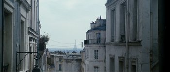 Movie still from “La Vie En Rose” (2007), directed by Olivier Dahan – A view of the eiffel tower from a building in paris , france; Wide shot, Low angle