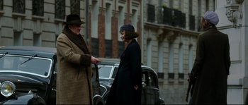 Movie still from “La Vie En Rose” (2007), directed by Olivier Dahan – A man and a woman talking to each other on the street; Medium shot, Over the shoulder angle