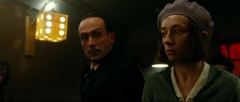 Movie still from “La Vie En Rose” (2007), directed by Olivier Dahan – A man and a woman standing next to each other; Close Up shot, Low angle