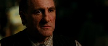 Movie still from “La Vie En Rose” (2007), directed by Olivier Dahan – An older man wearing a vest and a tie; Close Up shot, Low angle