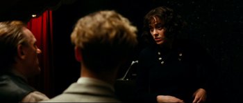 Movie still from “La Vie En Rose” (2007), directed by Olivier Dahan – A woman in a black jacket is looking at a man in a black jacket; Close Up shot, Over the shoulder angle