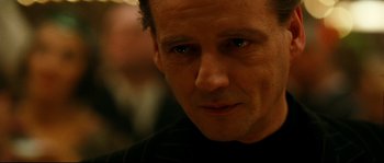 Movie still from “La Vie En Rose” (2007), directed by Olivier Dahan – A man's face in a black shirt; Close Up shot, Over the shoulder angle