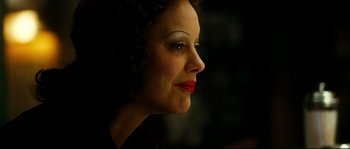 Movie still from “La Vie En Rose” (2007), directed by Olivier Dahan – A person with red lipstick on her lips; Close Up shot, Over the shoulder angle