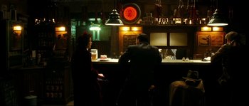 Movie still from “La Vie En Rose” (2007), directed by Olivier Dahan – A man and a woman sitting at a bar; Wide shot, Over the shoulder angle