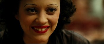Movie still from “La Vie En Rose” (2007), directed by Olivier Dahan – A woman's face with red lipstick; Close Up shot, Overhead angle
