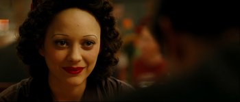 Movie still from “La Vie En Rose” (2007), directed by Olivier Dahan – A person wearing a black shirt; Close Up shot, High angle