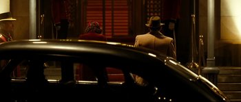 Movie still from “La Vie En Rose” (2007), directed by Olivier Dahan – A man and a woman sitting on a bench; Wide shot, Over the shoulder angle