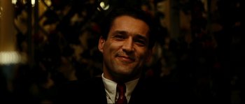 Movie still from “La Vie En Rose” (2007), directed by Olivier Dahan – A person wearing a suit and tie; Close Up shot, Low angle