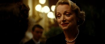Movie still from “La Vie En Rose” (2007), directed by Olivier Dahan – An older woman wearing a black suit and pearl necklace; Close Up shot, Over the shoulder angle