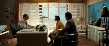 Movie still from “La Vie En Rose” (2007), directed by Olivier Dahan – A man and a woman sitting in front of a window; Wide shot, High angle