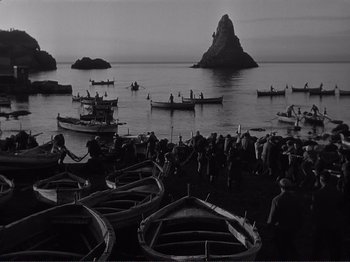 Movie still from “The Earth Trembles” (1948), directed by Luchino Visconti – A black and white photo of boats in the water; Extreme Wide shot, High angle
