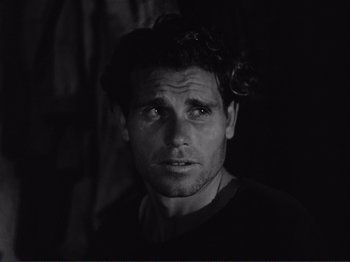 Movie still from “The Earth Trembles” (1948), directed by Luchino Visconti – Black and white photograph of a man looking into the distance; Close Up shot, Over the shoulder angle