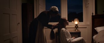 Movie still from “Lady Macbeth” (2016), directed by William Oldroyd – A woman is cutting the hair of a young girl; Medium shot, Over the shoulder angle