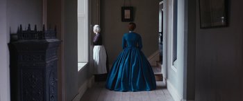 Movie still from “Lady Macbeth” (2016), directed by William Oldroyd – A woman in a long blue dress standing next to another woman; Wide shot, Over the shoulder angle