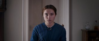 Movie still from “Lady Macbeth” (2016), directed by William Oldroyd – A woman in a blue dress is standing in a room; Close Up shot, Over the shoulder angle