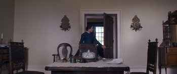 Movie still from “Lady Macbeth” (2016), directed by William Oldroyd – A woman standing in front of an open door; Wide shot, Low angle