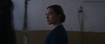 Movie still from “Lady Macbeth” (2016), directed by William Oldroyd – A woman standing in front of a white wall; Close Up shot, Low angle
