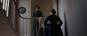 Movie still from “Lady Macbeth” (2016), directed by William Oldroyd – Two women in historical clothing stand in front of a doorway; Medium shot, Low angle