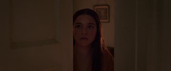 Movie still from “Lady Macbeth” (2016), directed by William Oldroyd – A woman standing in a dark room looking at the camera; Close Up shot, Over the shoulder angle