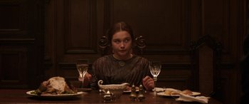 Movie still from “Lady Macbeth” (2016), directed by William Oldroyd – A woman sitting at a table with a bowl of food; Medium shot, High angle