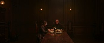 Movie still from “Lady Macbeth” (2016), directed by William Oldroyd – Two people sitting at a dinner table with wine glasses; Wide shot, High angle