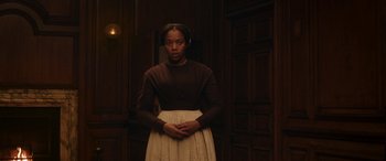 Movie still from “Lady Macbeth” (2016), directed by William Oldroyd – A woman standing in front of a wooden wall; Medium shot, High angle