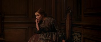 Movie still from “Lady Macbeth” (2016), directed by William Oldroyd – A woman in a dress sitting on a chair; Medium shot, High angle
