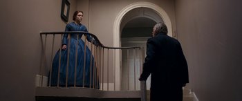 Movie still from “Lady Macbeth” (2016), directed by William Oldroyd – An older man and a young woman standing on the stairs; Wide shot, Low angle