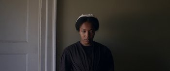 Movie still from “Lady Macbeth” (2016), directed by William Oldroyd – A woman wearing a black shirt and a white headband; Close Up shot, Low angle