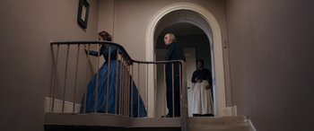 Movie still from “Lady Macbeth” (2016), directed by William Oldroyd – A man and a woman standing at the bottom of a staircase; Wide shot, Low angle
