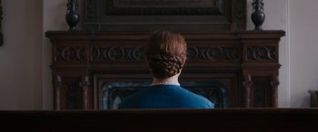 Movie still from “Lady Macbeth” (2016), directed by William Oldroyd – A woman sitting in front of an ornate wall; Close Up shot, Overhead angle