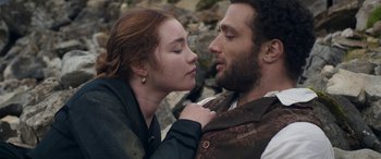 Movie still from “Lady Macbeth” (2016), directed by William Oldroyd – A man and a woman are kissing in a rocky area; Close Up shot, Over the shoulder angle