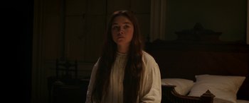 Movie still from “Lady Macbeth” (2016), directed by William Oldroyd – A woman with long brown hair standing in a room; Medium shot, Over the shoulder angle