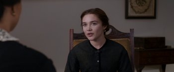 Movie still from “Lady Macbeth” (2016), directed by William Oldroyd – A woman in black shirt sitting in a chair; Close Up shot, Over the shoulder angle