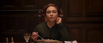 Movie still from “Lady Macbeth” (2016), directed by William Oldroyd – A woman sitting at a table with a plate of food; Medium shot, Over the shoulder angle