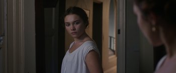 Movie still from “Lady Macbeth” (2016), directed by William Oldroyd – A young woman standing in a room next to a door; Medium shot, Over the shoulder angle