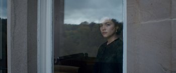 Movie still from “Lady Macbeth” (2016), directed by William Oldroyd – A woman looking out of a window at a forest; Medium shot, Over the shoulder angle