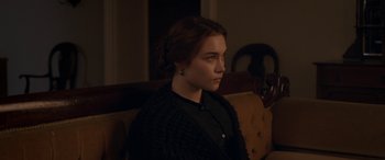 Movie still from “Lady Macbeth” (2016), directed by William Oldroyd – A woman sitting on a couch looking to her left; Close Up shot, Over the shoulder angle
