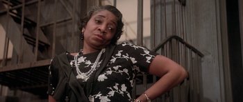 Movie still from “Lady Sings the Blues” (1972), directed by Sidney J. Furie – An older woman in a black and white floral dress; Close Up shot, Low angle